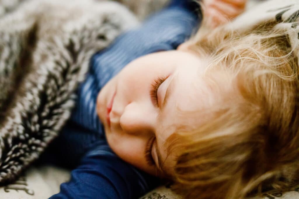 Sleep coaching myths often create confusion for parents; this image of a peacefully sleeping child highlights the truth about achieving better family sleep.