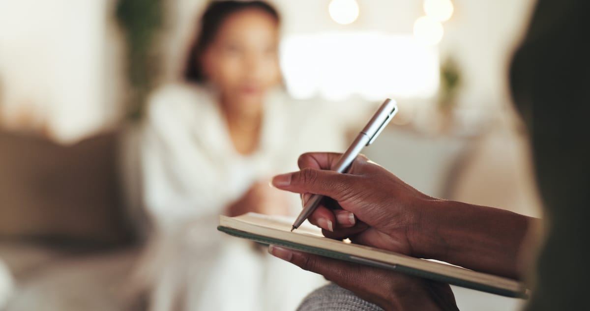 Close-Up Of A Sleep Coach Taking Notes During A Session, Illustrating The Application Of Sleep Psychology To Improve Sleep Habits And Well-Being.